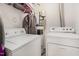 Efficient laundry area featuring modern washer, dryer, and storage shelving for added convenience at 1220 Canyon Rock Ct # 107, Raleigh, NC 27610