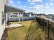 A covered patio and well-maintained lawn within a fenced backyard offer relaxation and privacy at 1236 Shadow Shade, Wake Forest, NC 27587
