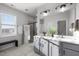 Contemporary bathroom with double vanity, sleek fixtures, and a bright, window-lit space at 1236 Shadow Shade, Wake Forest, NC 27587