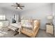 Airy bedroom showcasing a queen bed, charming crib, and a stylish accent bench at 1236 Shadow Shade, Wake Forest, NC 27587