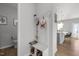A stylish entryway with a coat rack and storage bench leading to an open-concept kitchen at 1236 Shadow Shade, Wake Forest, NC 27587