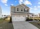 Beautiful two-story house featuring a two-car garage, landscaped yard, and inviting front porch at 1236 Shadow Shade, Wake Forest, NC 27587