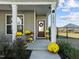 Inviting front porch adorned with seasonal decor and a charming wreath on the front door at 1236 Shadow Shade, Wake Forest, NC 27587
