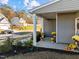 View of the side of this covered front porch with decorative plants and pumpkins at 1236 Shadow Shade, Wake Forest, NC 27587