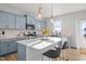 Modern kitchen featuring blue cabinets, a center island with seating, and stainless steel appliances at 1236 Shadow Shade, Wake Forest, NC 27587