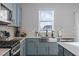 Modern kitchen featuring stainless steel appliances, a farmhouse sink, and grey subway tile backsplash at 1236 Shadow Shade, Wake Forest, NC 27587