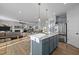 Bright kitchen with stainless steel appliances, marble countertops, and a view of the living area, with hardwood floors at 1236 Shadow Shade, Wake Forest, NC 27587