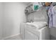 Efficient laundry room with modern washer and dryer, storage shelving, and ample space at 1236 Shadow Shade, Wake Forest, NC 27587