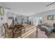 Open concept living space with a dining area, modern kitchen, and plenty of natural light, with hardwood floors at 1236 Shadow Shade, Wake Forest, NC 27587