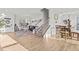 Spacious and well-lit living area with hardwood floors, a staircase, and seamless transition to dining area at 1236 Shadow Shade, Wake Forest, NC 27587
