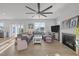 Comfortable living room with a large sectional sofa, fireplace, large ceiling fan, and outdoor access at 1236 Shadow Shade, Wake Forest, NC 27587