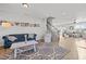 Inviting living room featuring hardwood floors, a stylish blue sofa, and staircase to the upper level at 1236 Shadow Shade, Wake Forest, NC 27587