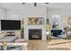 Bright living room with a fireplace, mounted television, hardwood flooring, and natural light at 1236 Shadow Shade, Wake Forest, NC 27587