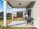 Covered patio with chairs on a patterned rug, perfect for outdoor relaxation and entertaining at 1236 Shadow Shade, Wake Forest, NC 27587