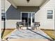 Covered patio with chairs on patterned rug, offering a cozy outdoor extension of the home at 1236 Shadow Shade, Wake Forest, NC 27587