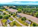Wide aerial view showcasing the homes and expansive fields with natural foliage in the neighborhood at 128 Christy Ln, Dunn, NC 28334
