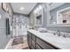 Updated bathroom featuring a double vanity with a marble countertop and decorative shower curtain at 128 Christy Ln, Dunn, NC 28334