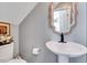 Small bathroom featuring a pedestal sink, toilet, and decorative mirror at 128 Christy Ln, Dunn, NC 28334