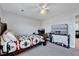 Bedroom features a ceiling fan, television, and a comfortable bed with colorful linens at 128 Christy Ln, Dunn, NC 28334