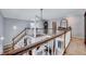 Bright foyer featuring staircase, wooden railings, and views to both the upstairs and downstairs living areas at 128 Christy Ln, Dunn, NC 28334