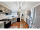 Well-lit kitchen features gray cabinets, wood floors, stainless steel appliances, and a stylish light fixture at 128 Christy Ln, Dunn, NC 28334