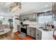 Bright kitchen with gray cabinets, marble countertops, stainless steel appliances, and a view into dining area at 128 Christy Ln, Dunn, NC 28334