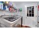 Laundry room featuring a modern washer and dryer set and storage shelves with cleaning supplies at 128 Christy Ln, Dunn, NC 28334
