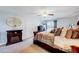 Bedroom featuring a large bed, ceiling fan, and a decorative fireplace at 128 Christy Ln, Dunn, NC 28334