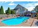 Sparkling in-ground pool surrounded by a patio, lush landscaping, and comfortable seating areas at 128 Christy Ln, Dunn, NC 28334