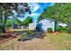 Exterior view of a well-maintained shed in a landscaped backyard, providing ample storage space at 128 Christy Ln, Dunn, NC 28334