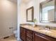 Bathroom boasts double sinks with granite counters and dark wood cabinets at 1314 Cornell Pl, Raleigh, NC 27607