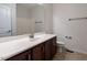 Bathroom featuring large mirror over single vanity with dark wood cabinets and tile floor at 1314 Cornell Pl, Raleigh, NC 27607
