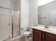 Clean bathroom with a glass-enclosed shower, a white toilet, and a wooden vanity with a sink and mirror at 1314 Cornell Pl, Raleigh, NC 27607
