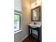 Charming bathroom with a vanity sink and a window offering natural light and outdoor views at 1314 Cornell Pl, Raleigh, NC 27607