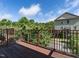 Wood deck features decorative railings with view of lush trees and nearby homes at 1314 Cornell Pl, Raleigh, NC 27607