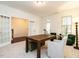 Spacious home office with a dark wooden desk, comfortable seating, and lots of natural light through the windows at 1314 Cornell Pl, Raleigh, NC 27607