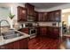 Well-equipped kitchen boasts cherry cabinets, granite counters, and stainless steel appliances at 1314 Cornell Pl, Raleigh, NC 27607