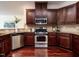 This kitchen features stainless steel appliances, cherry cabinets, and granite countertops at 1314 Cornell Pl, Raleigh, NC 27607
