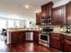 Open kitchen with stainless steel appliances and breakfast bar, ideal for casual dining at 1314 Cornell Pl, Raleigh, NC 27607