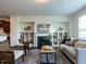 Elegant living room with a cozy fireplace, built-in shelving, and stylish seating, ideal for relaxation and socializing at 1314 Cornell Pl, Raleigh, NC 27607