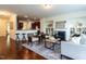 Open-concept living room with fireplace flows into the modern kitchen with a breakfast bar at 1314 Cornell Pl, Raleigh, NC 27607
