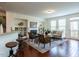 Inviting living room featuring hardwood floors, a fireplace, built-in shelving, and comfortable seating for relaxation at 1314 Cornell Pl, Raleigh, NC 27607