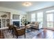 Stylish living room with a fireplace, built-in shelves, comfortable seating, and hardwood floors, perfect for entertaining at 1314 Cornell Pl, Raleigh, NC 27607
