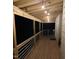 View of covered back porch featuring wood floors and wood railing with string lights at 1345 Ellis Rd, Durham, NC 27703