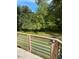 View from the backyard deck overlooking a lush yard with mature trees at 1345 Ellis Rd, Durham, NC 27703