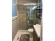 Bathroom featuring a modern vanity, tiled shower with glass door, and storage shelves at 1345 Ellis Rd, Durham, NC 27703