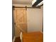 Rustic barn door feature in a dining area with wood table and modern light fixture at 1345 Ellis Rd, Durham, NC 27703