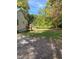 A view of the side of a house with a deck, stairs, and a lush yard at 1345 Ellis Rd, Durham, NC 27703