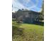 View of a two-story home featuring a spacious yard and a deck with stairs at 1345 Ellis Rd, Durham, NC 27703