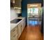Galley style kitchen with countertops, wooden floors and stainless steel appliances at 1345 Ellis Rd, Durham, NC 27703